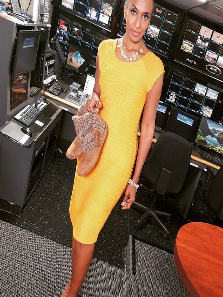 She is in a yellow long one-piece.